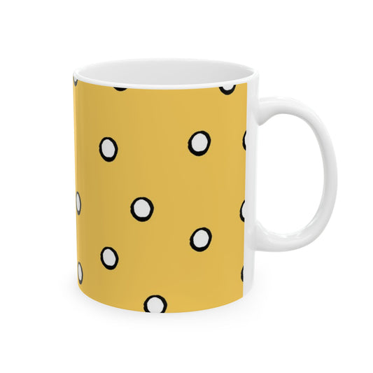 Yellow mug with black-outlined white polka dots. White handle and interior.