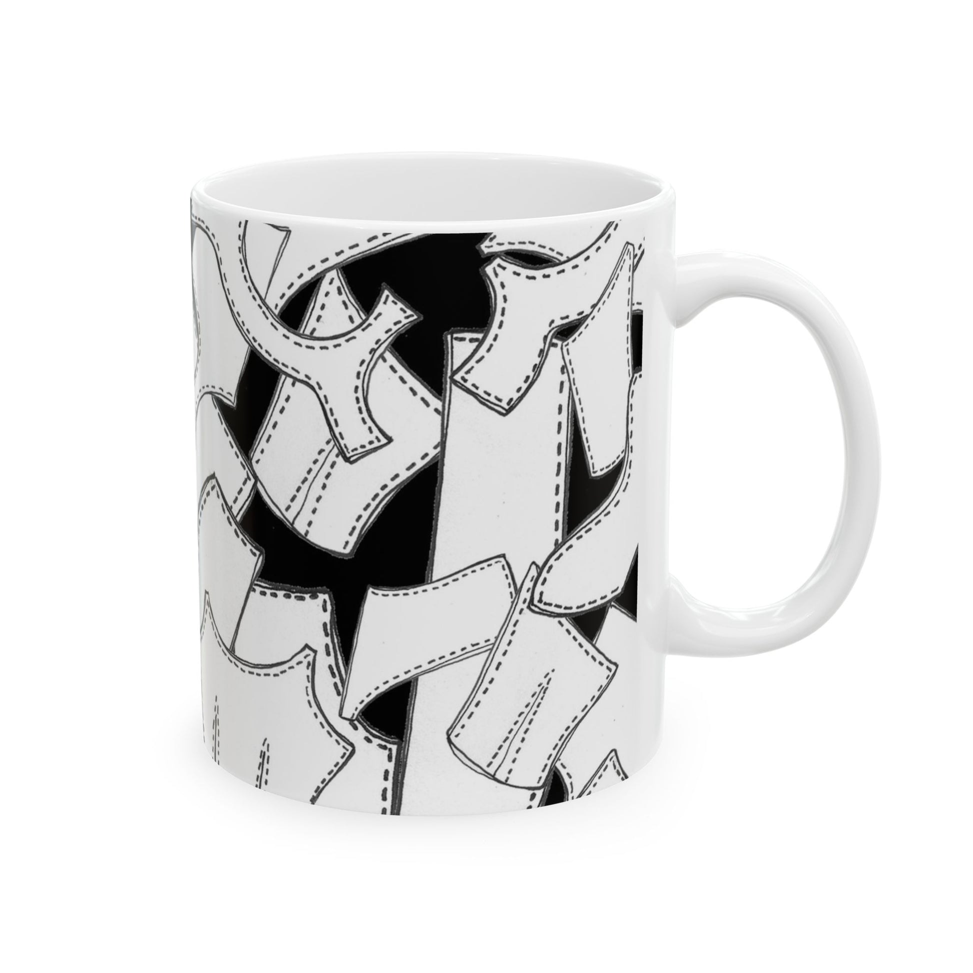 White mug with black and white abstract pattern of stitched fabric pieces.