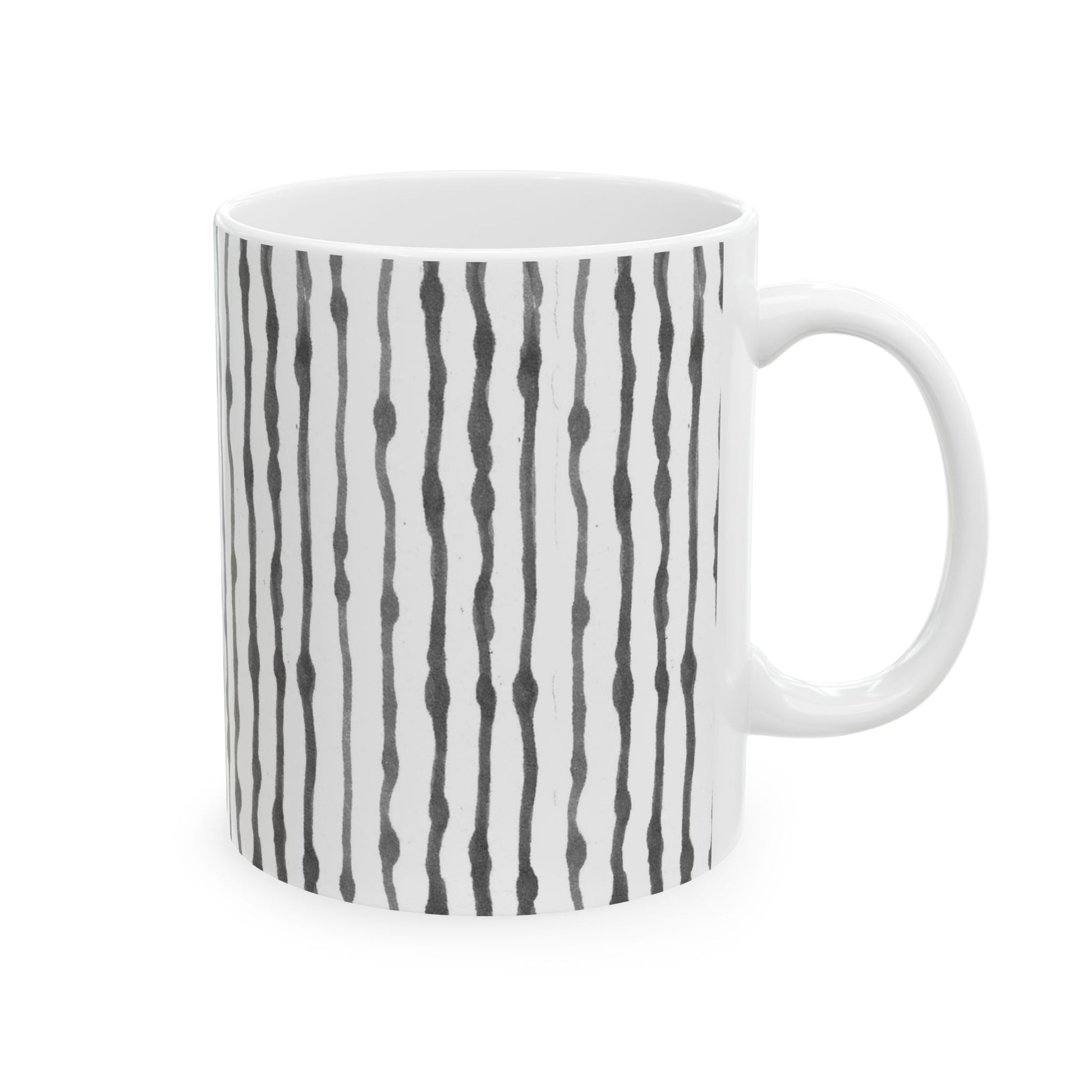 White mug with vertical wavy black lines evenly spaced around its surface.