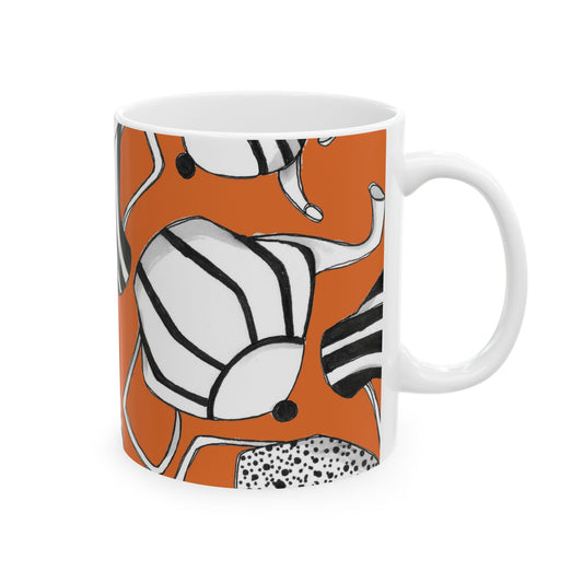 White mug with abstract black and white patterns on an orange background.