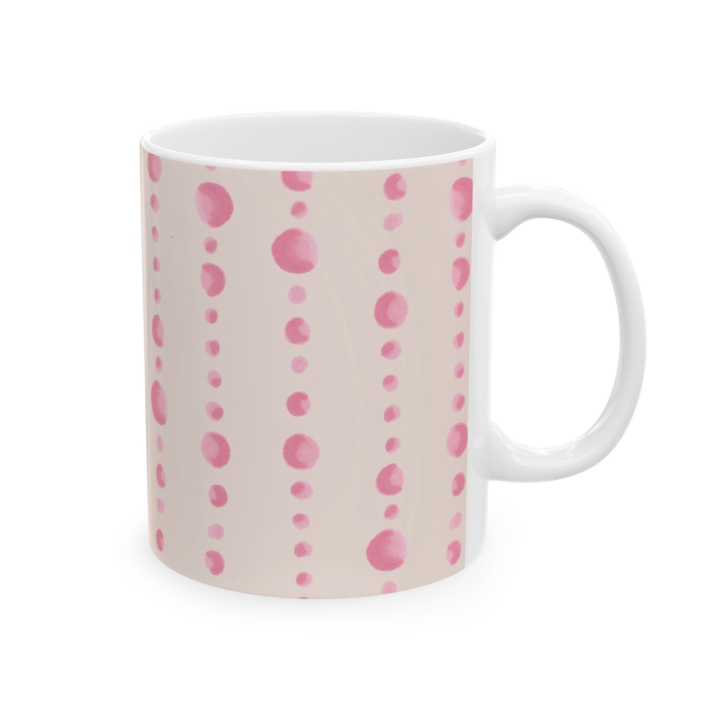 White mug with vertical pink polka dot patterns on a light beige background.