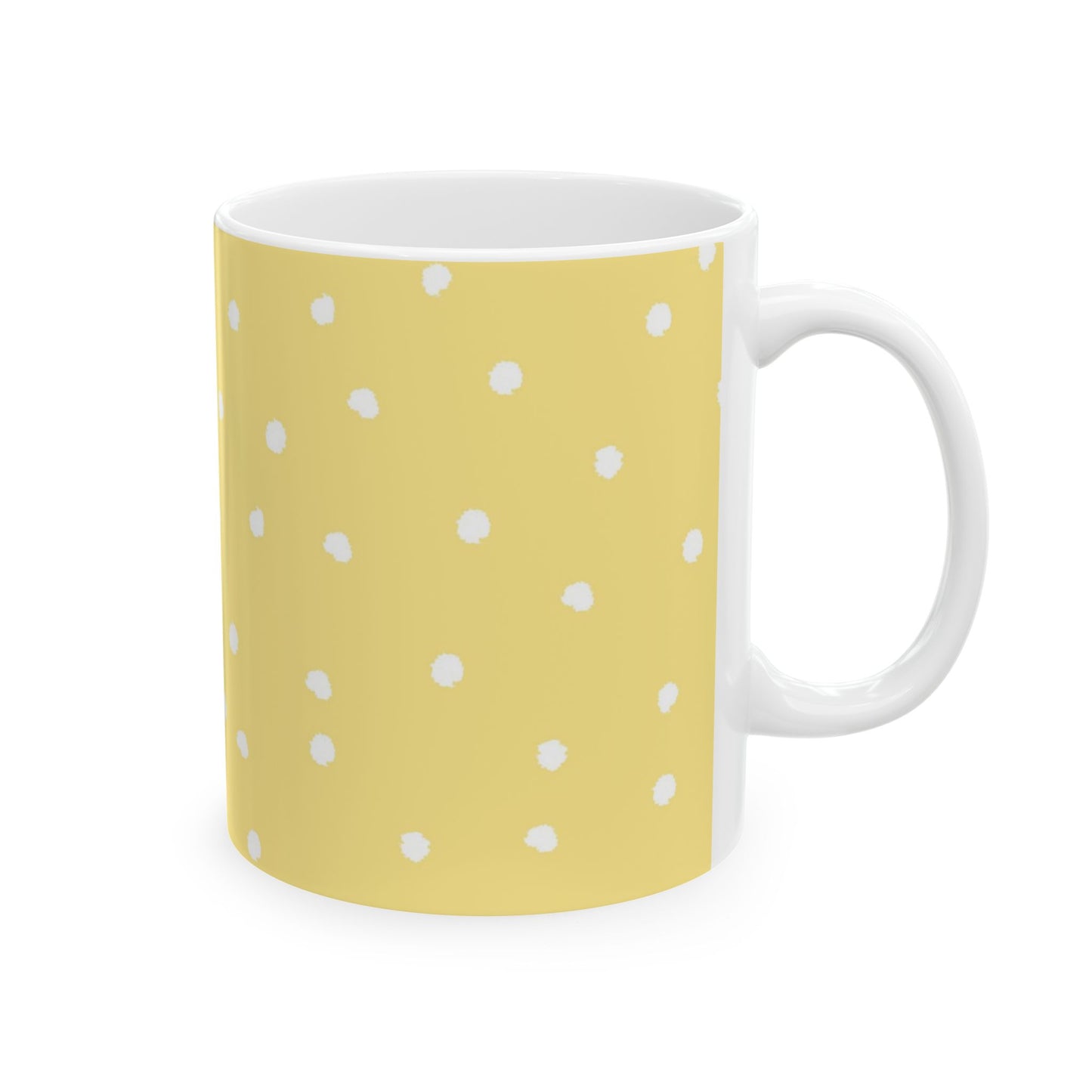 Yellow mug with white polka dots, white interior, and a white handle.
