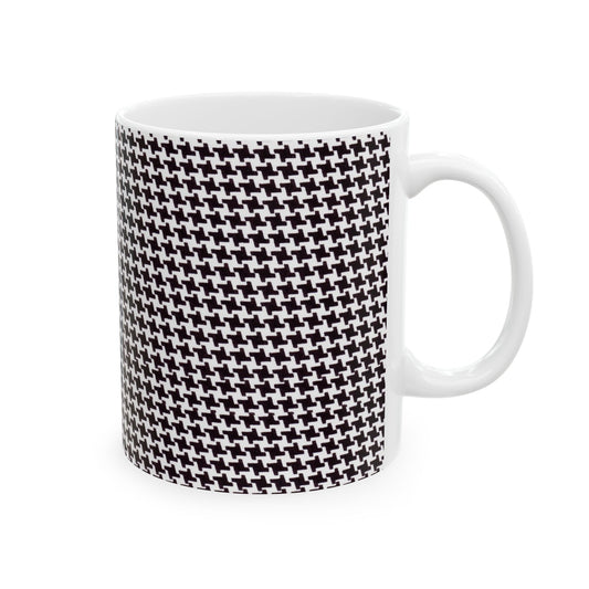 White mug with black and white houndstooth pattern covering its surface.