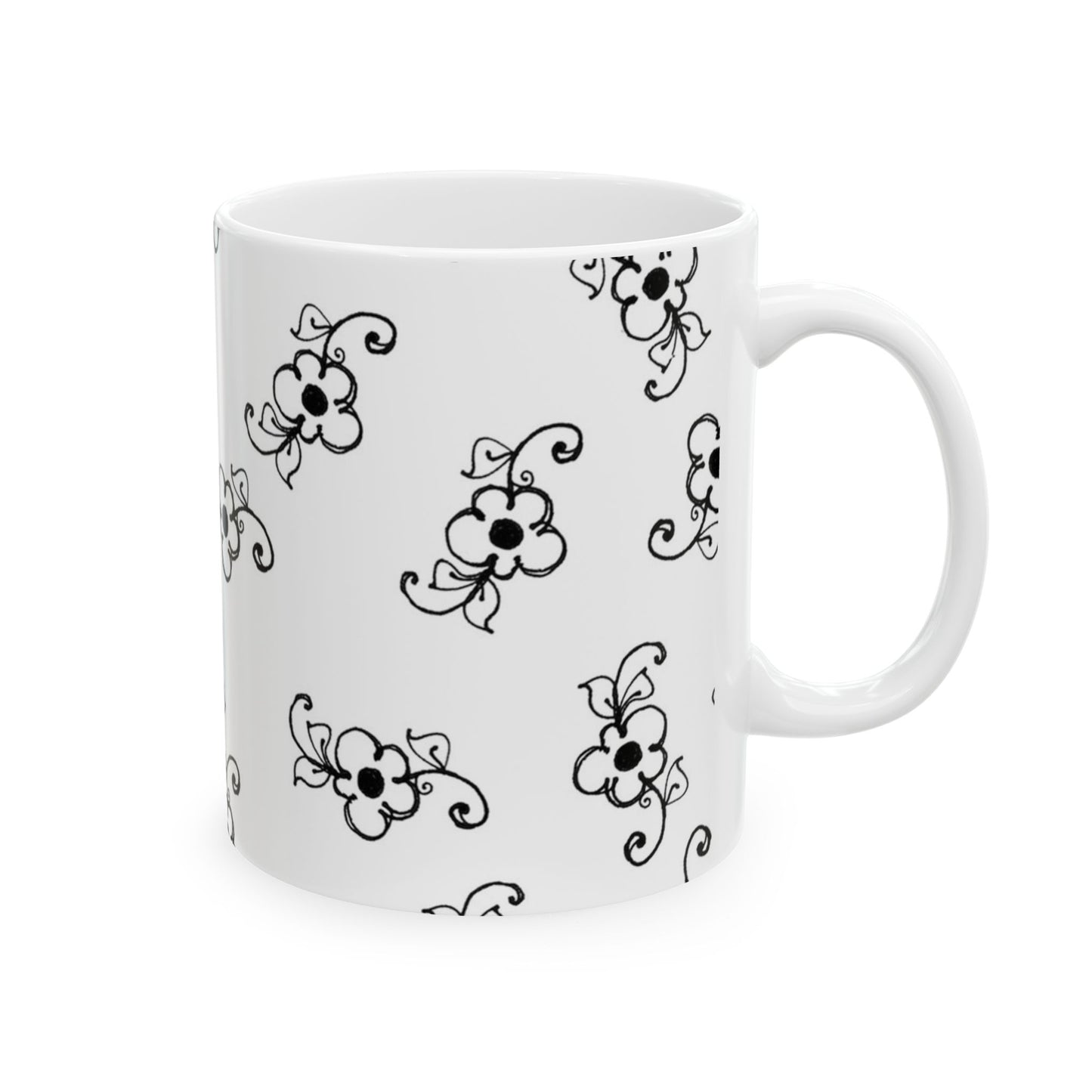 White mug with black floral patterns, featuring swirls and flowers evenly distributed.