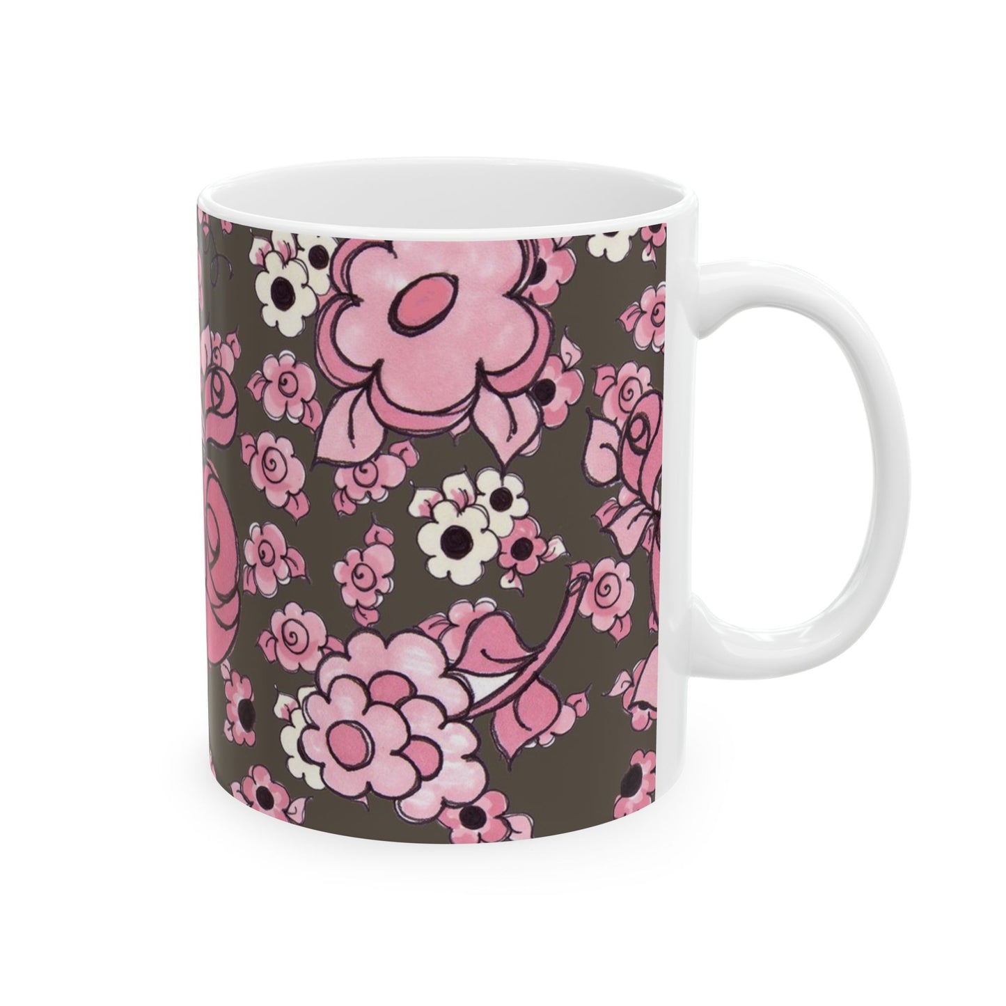 White mug with pink and white floral pattern on a dark background.