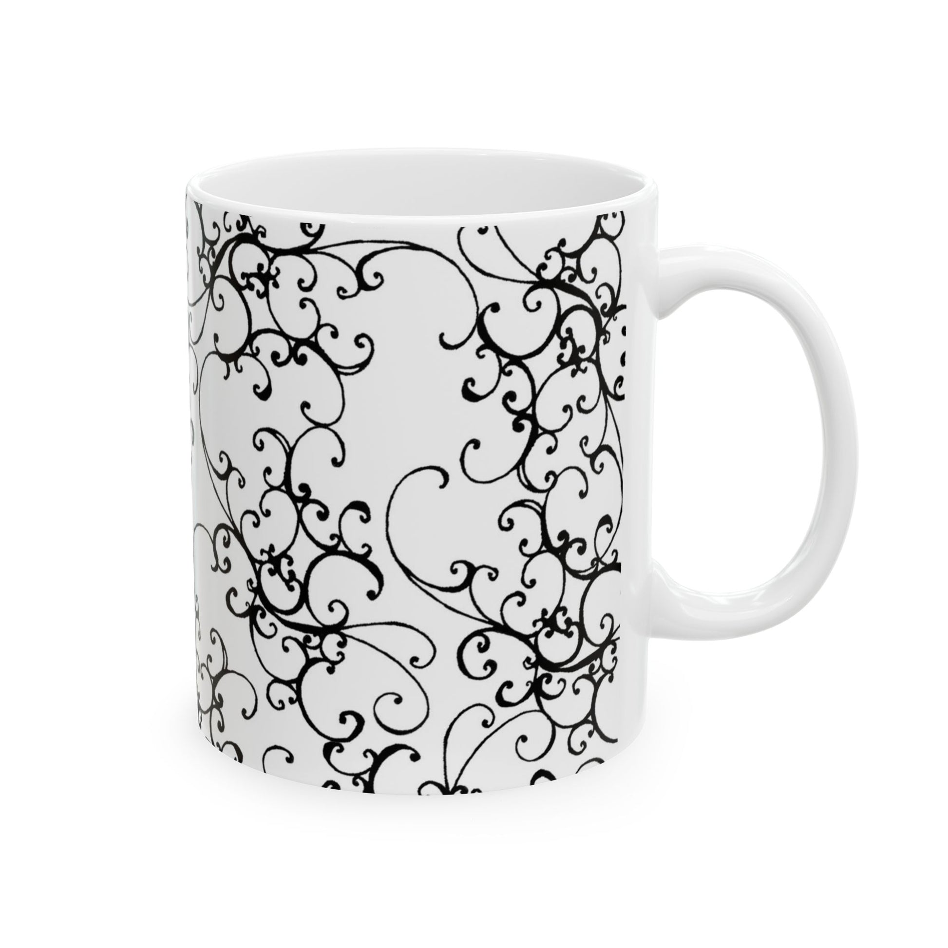 White mug with intricate black floral swirls and a glossy finish.
