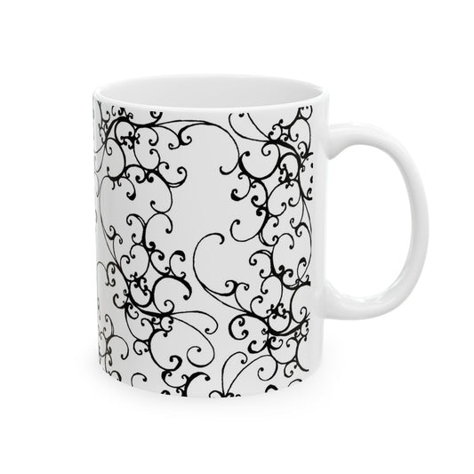White mug with intricate black floral swirls and a glossy finish.
