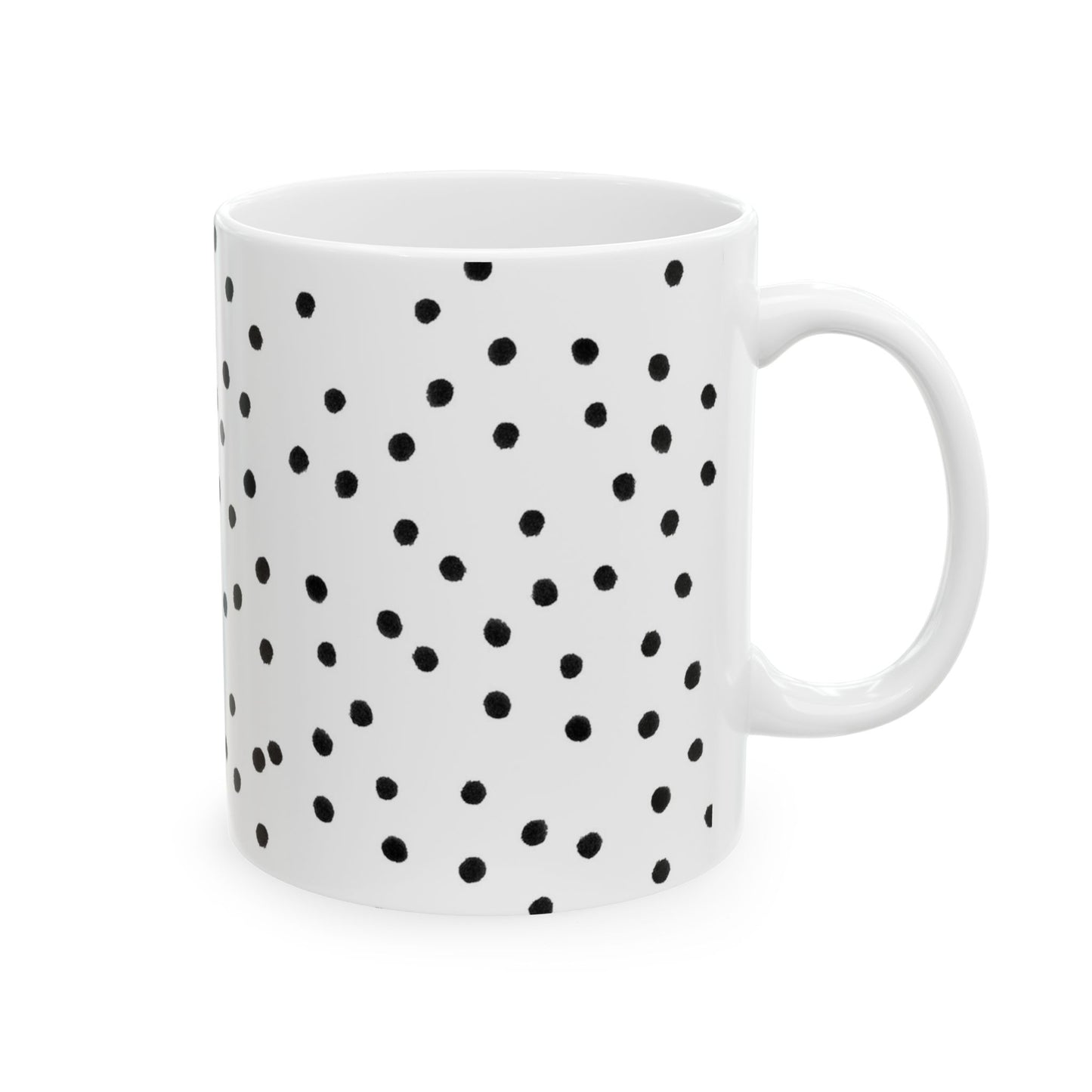 White mug with scattered black polka dots, featuring a simple handle design.