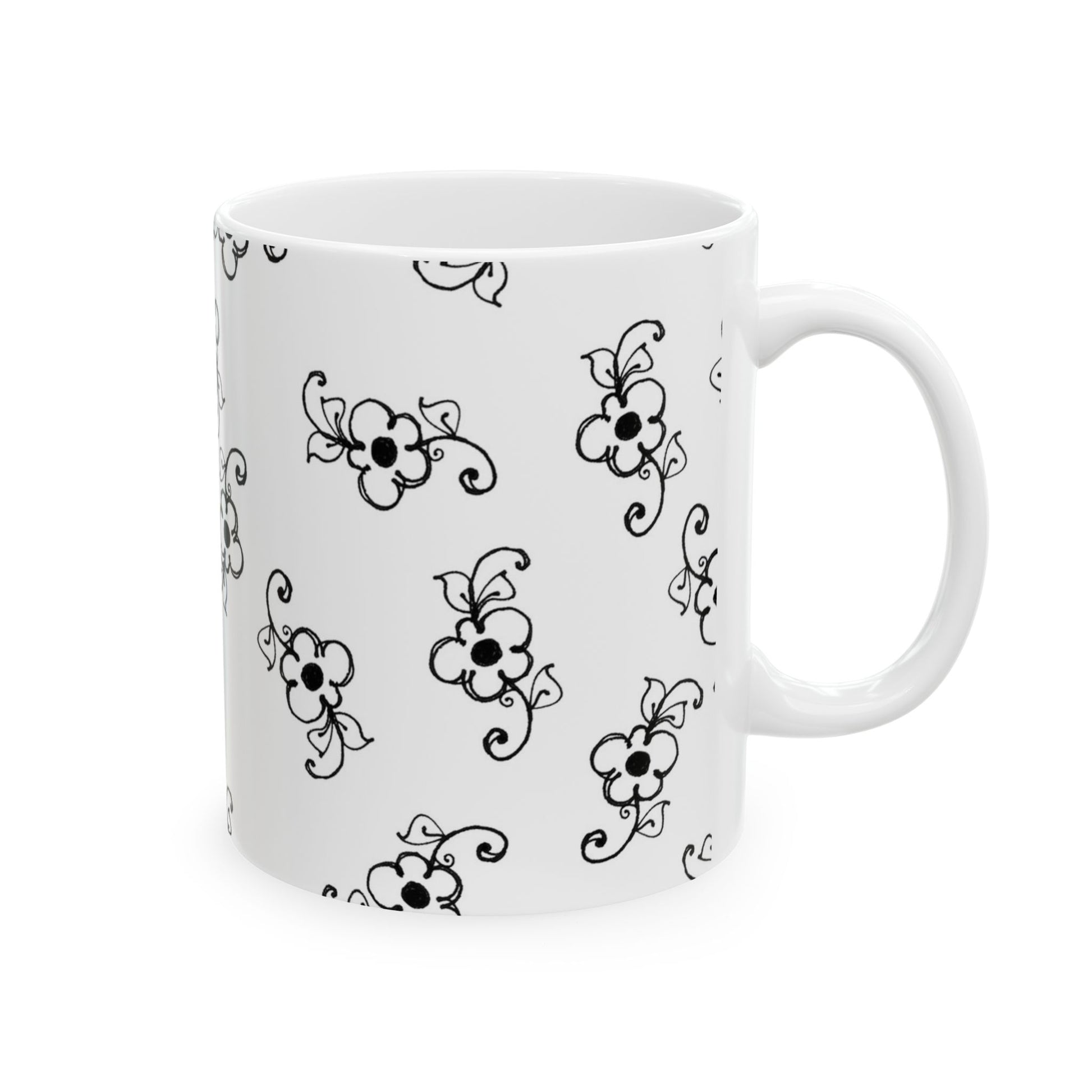 White mug with black floral pattern, featuring stylized flowers and swirls evenly distributed.