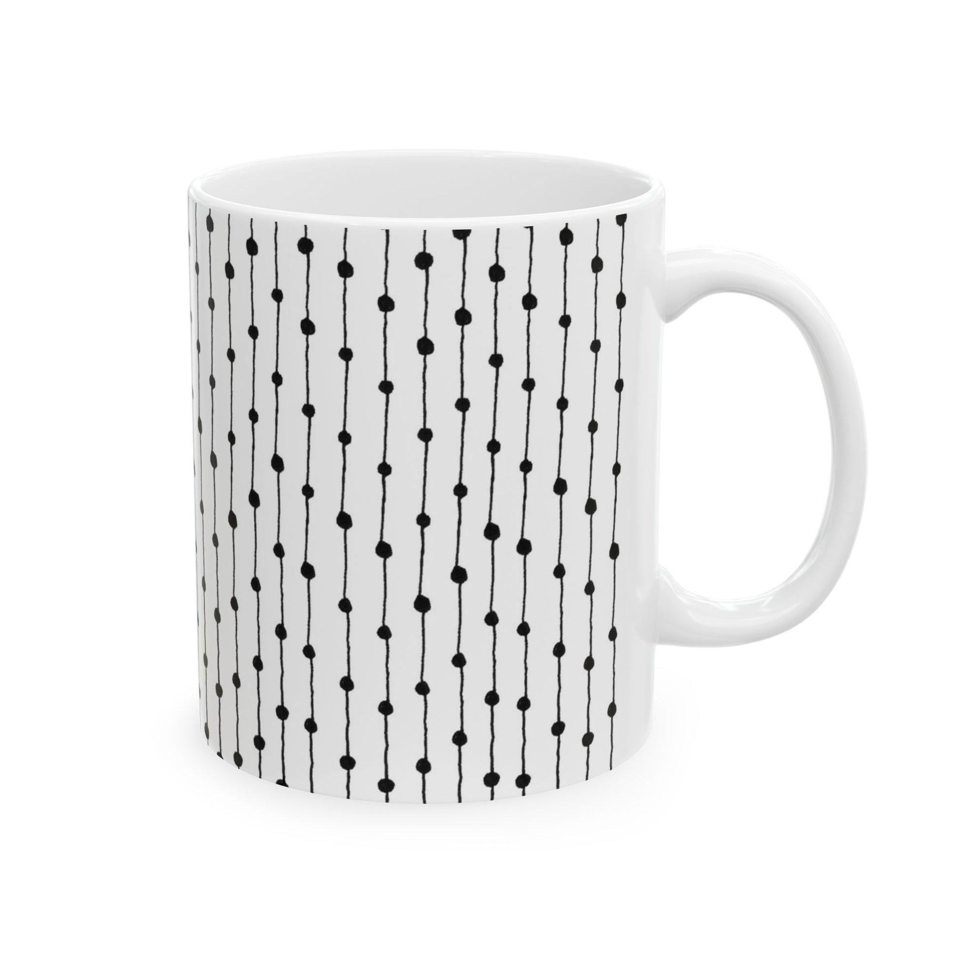 White mug with vertical black dotted lines pattern.