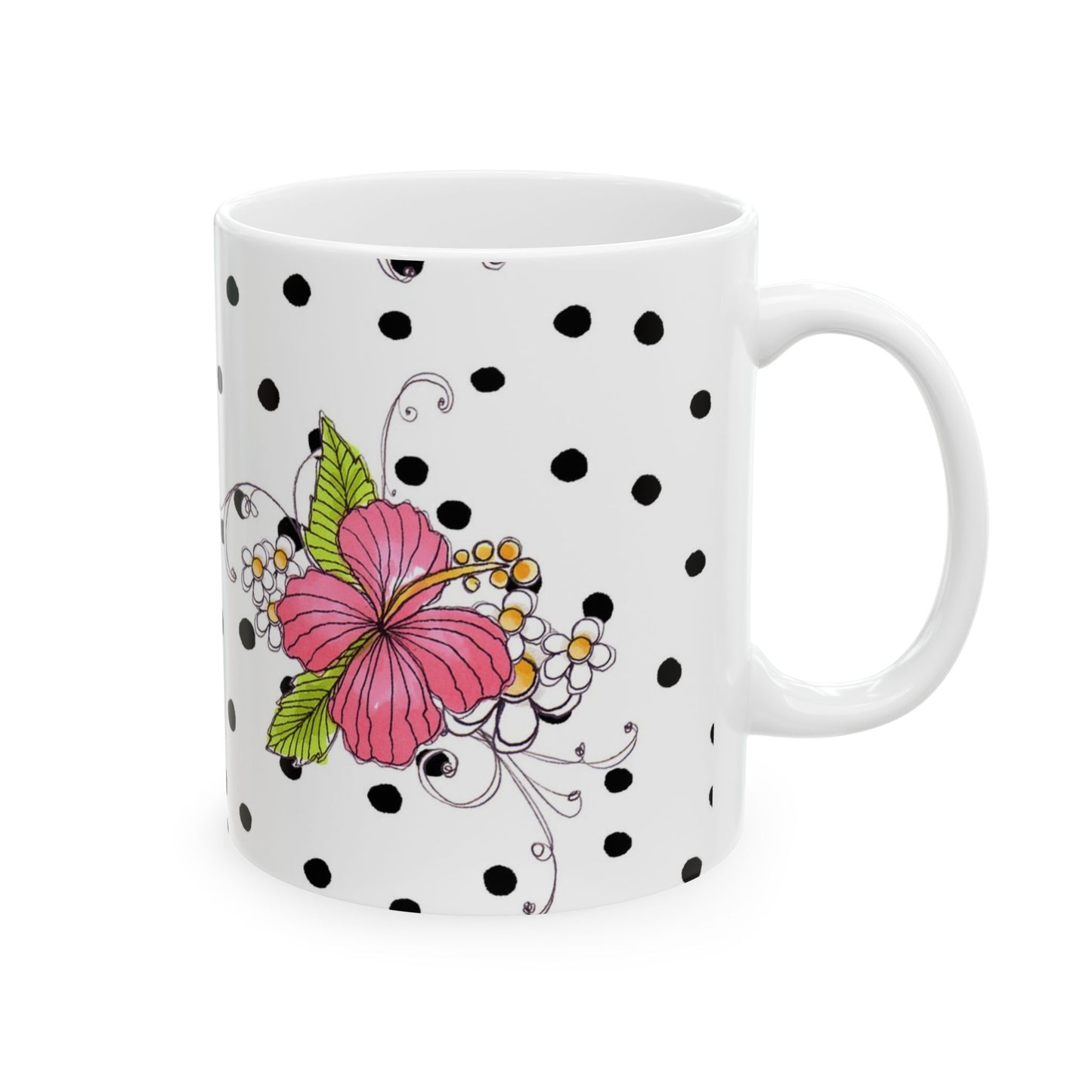 White mug with black polka dots, featuring a pink flower with green leaves and smaller floral accents.