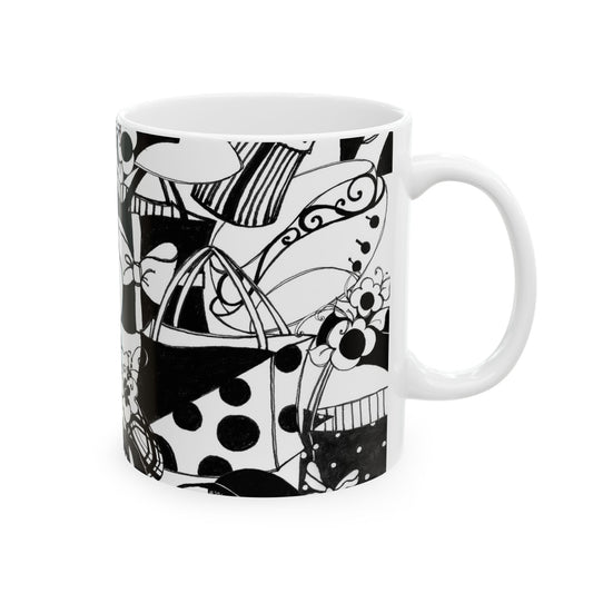 White mug with black abstract patterns, including polka dots, stripes, and swirls.