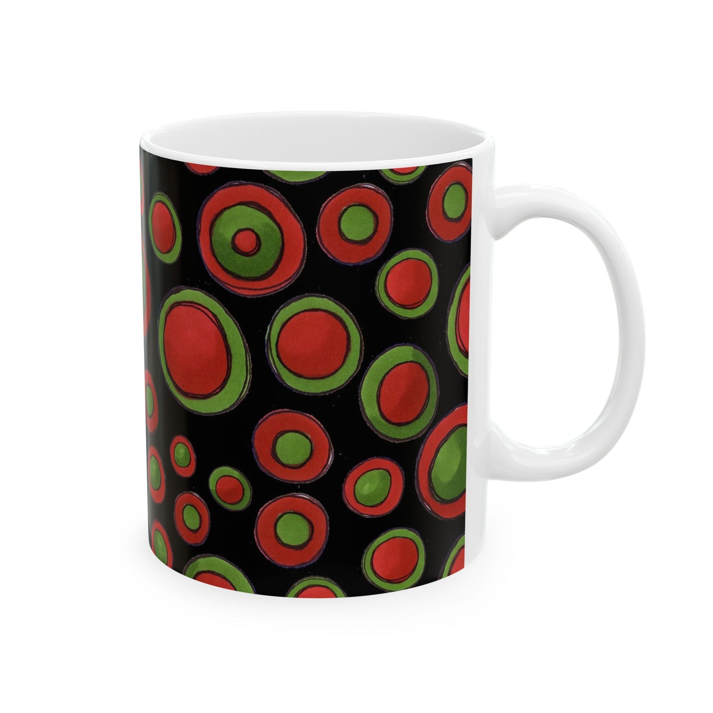 White mug with red and green concentric circles on a black background.