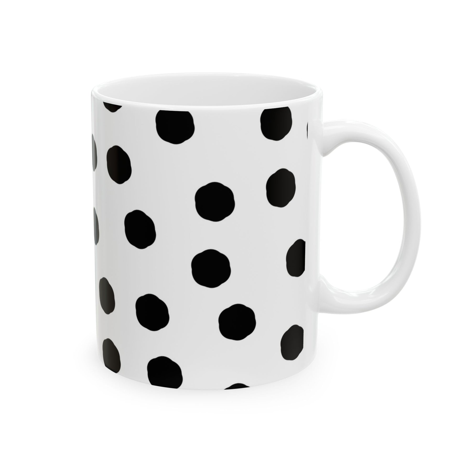 White mug with black polka dots in a regular pattern.