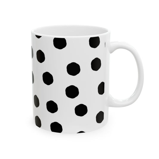 White mug with black polka dots in a regular pattern.