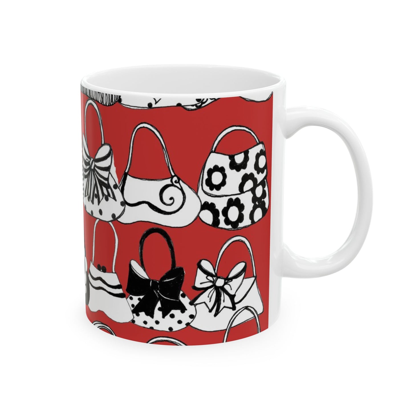 White mug with black and white handbags pattern on a red background.
