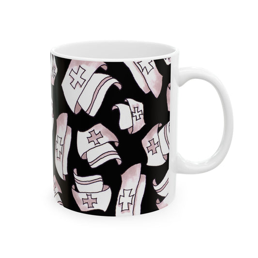 White mug with black background featuring pink nurse caps with red crosses in a repeating pattern.