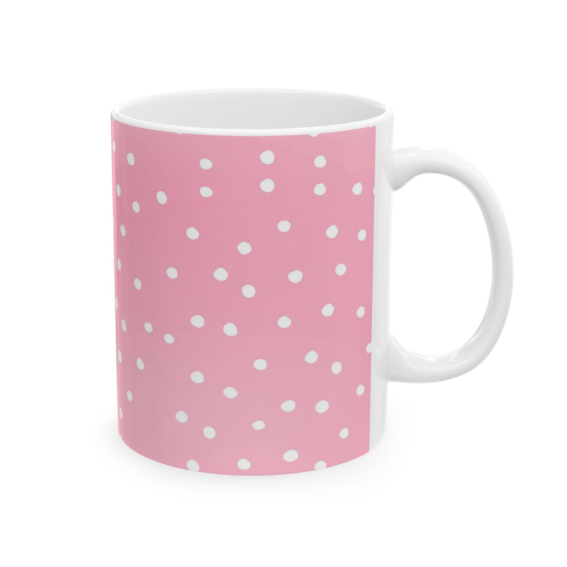 Pink mug with white polka dots, featuring a glossy finish and a white handle.