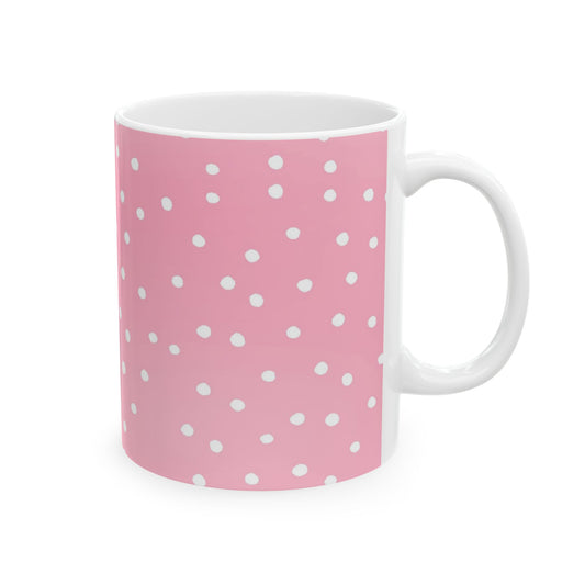 Pink mug with white polka dots, featuring a glossy finish and a white handle.