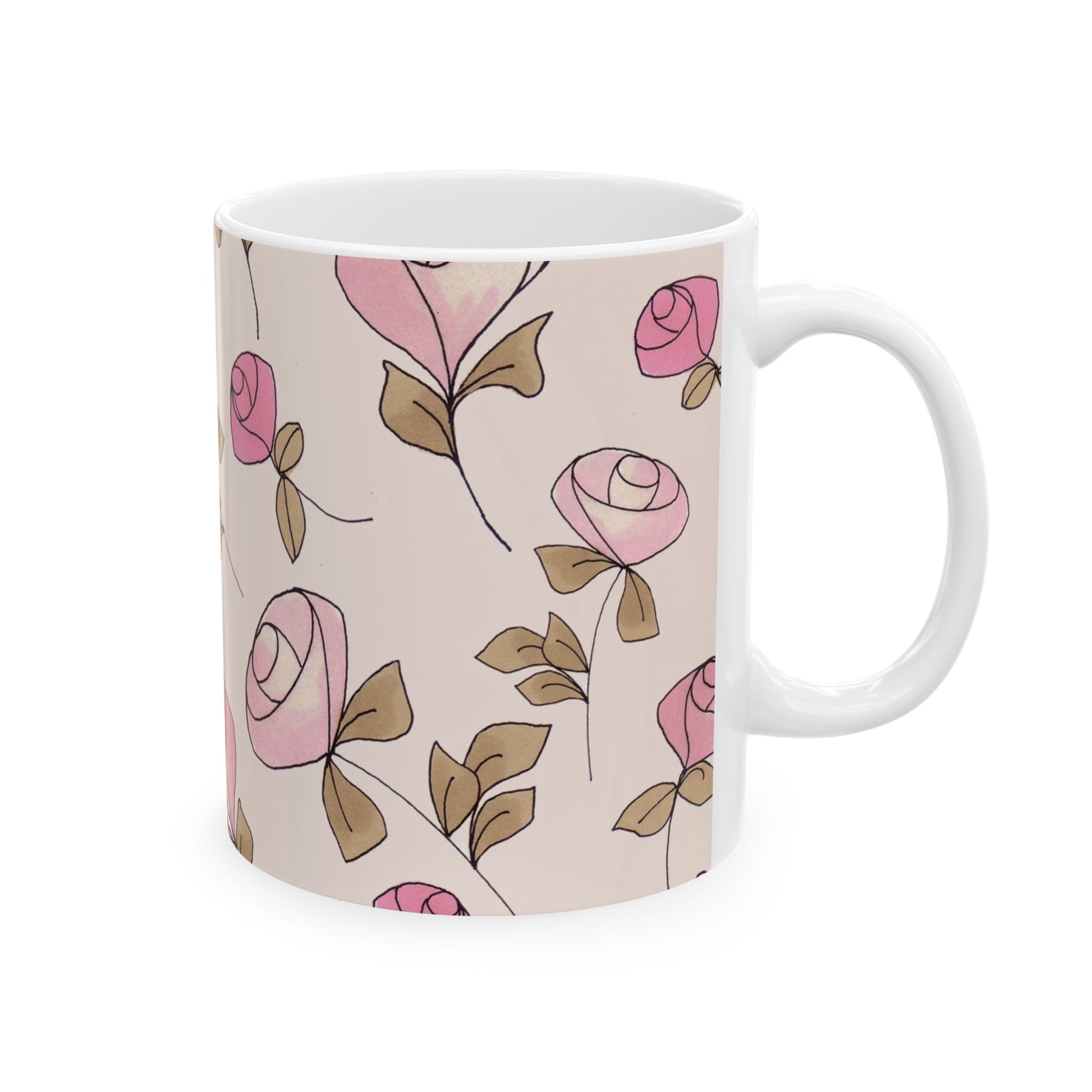 White mug with pink rose pattern and brown leaves on a beige background.