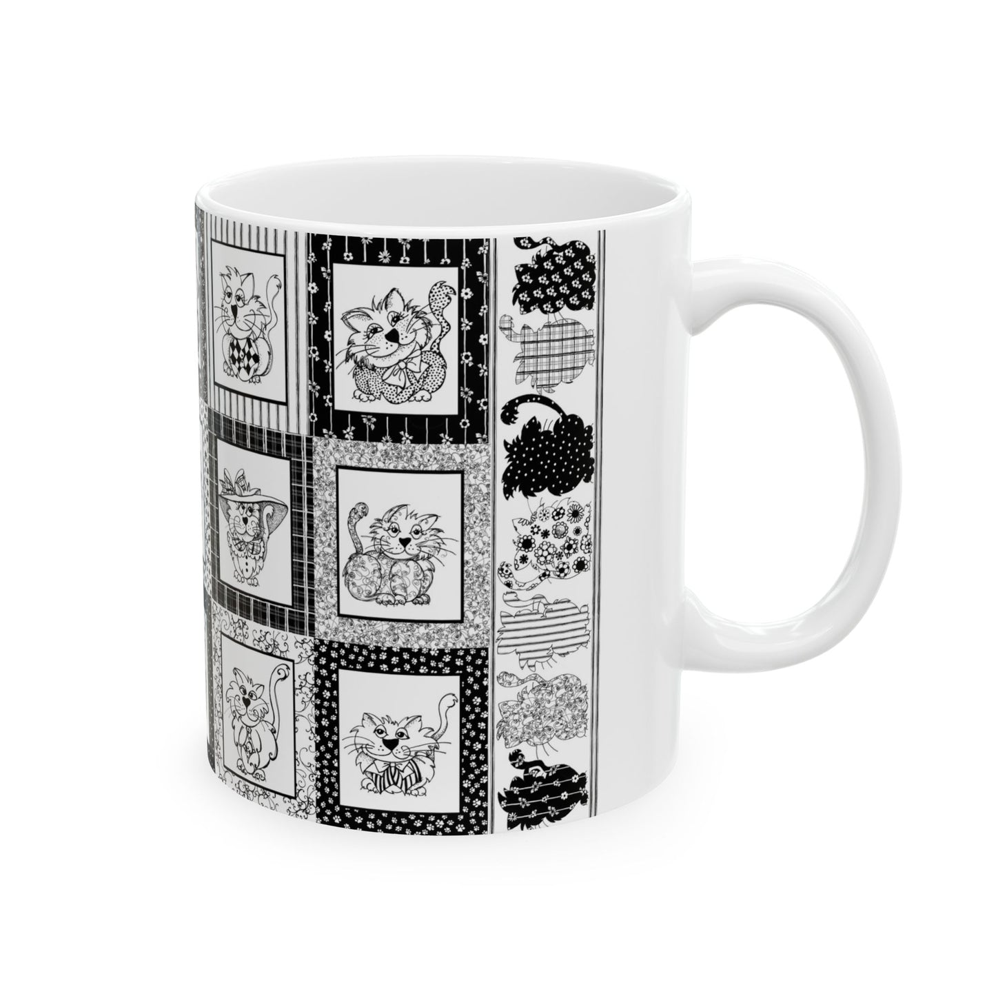 White mug with black-and-white cat illustrations in patterned squares.