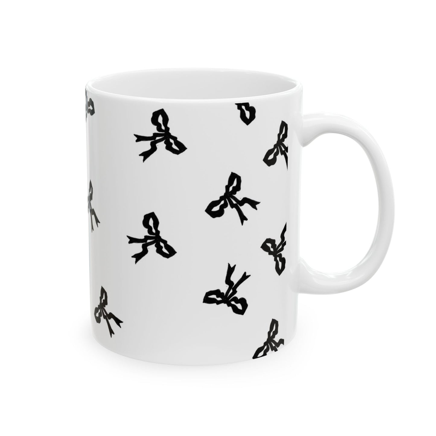 White mug with scattered black bow patterns.