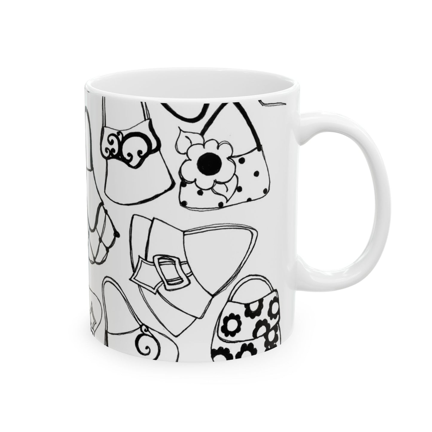 White mug with black outlined handbag designs, featuring floral and abstract patterns.