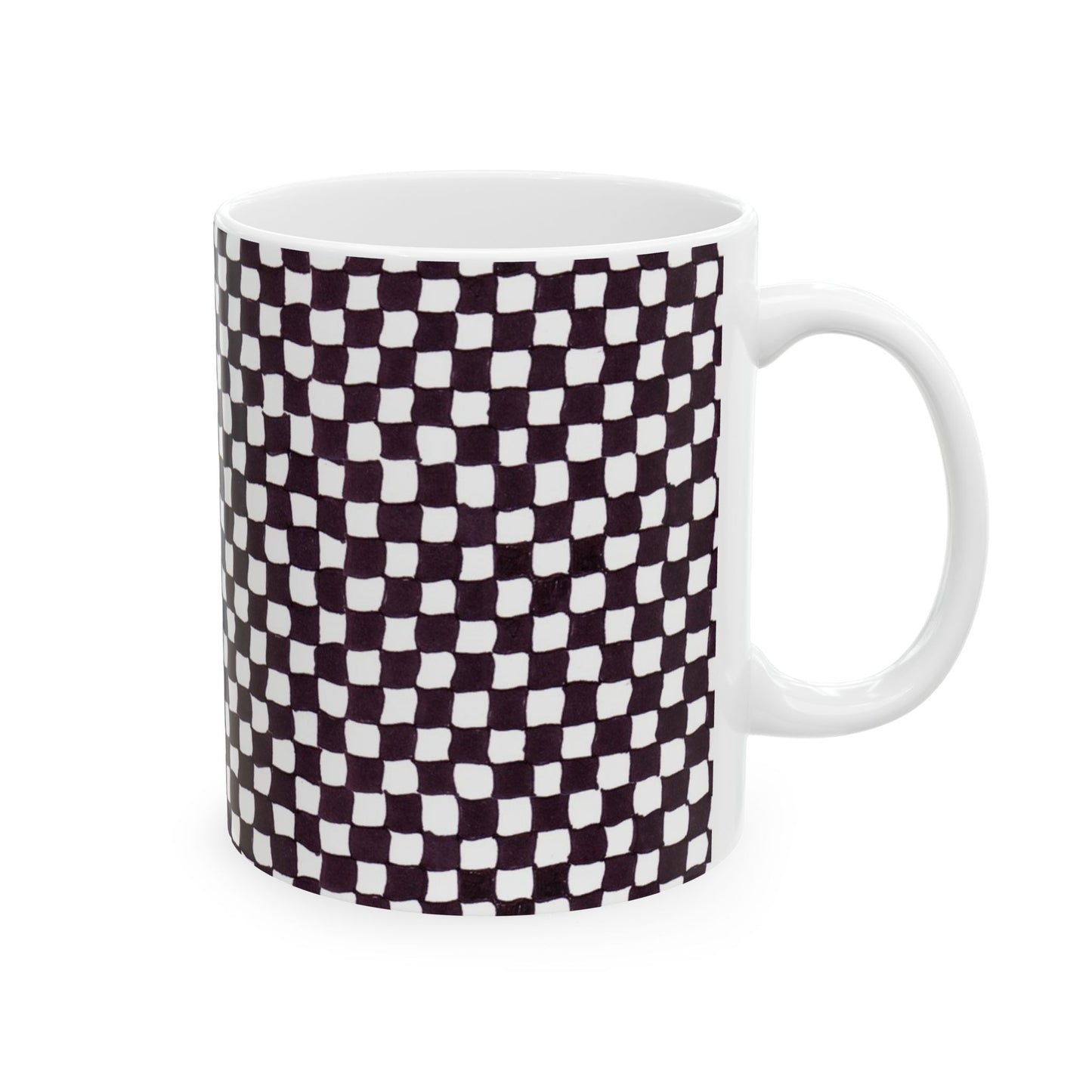 White mug with a black and white checkered pattern, featuring slightly irregular squares.