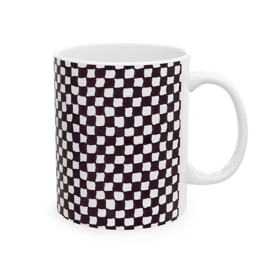 White mug with a black and white checkered pattern, featuring slightly irregular squares.