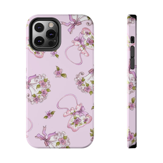 Pink phone case with floral pattern, featuring purple and green flowers on a pastel background.