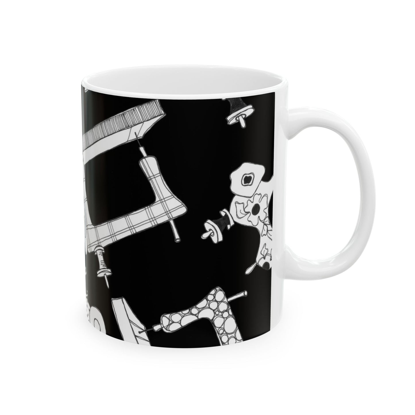 White mug with black background featuring abstract, white patterned shapes.