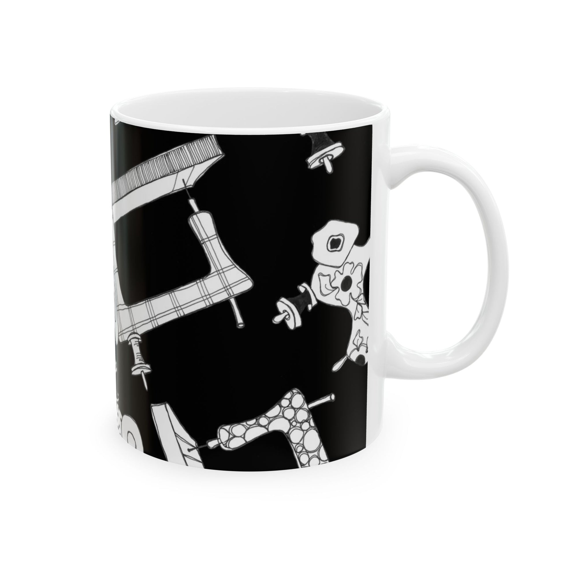 White mug with black background featuring abstract, white patterned shapes.