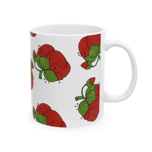 White mug with red and green cartoon flowers scattered across the surface.