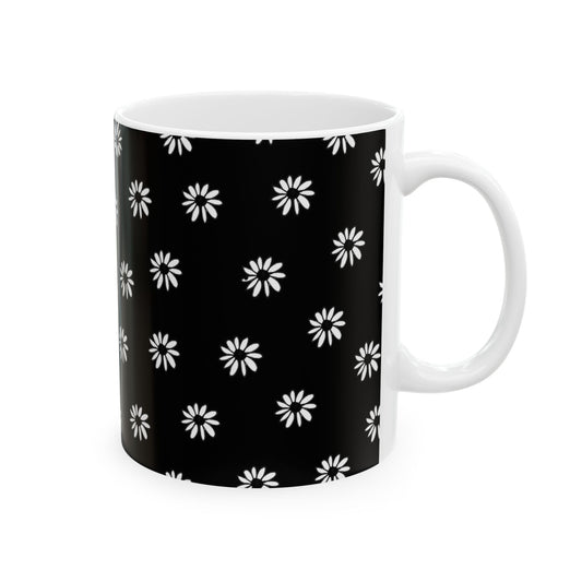 Black mug with white daisy pattern, white interior and handle.