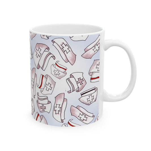 White mug with a pattern of nurse hats featuring red cross symbols and stripes on a light background.