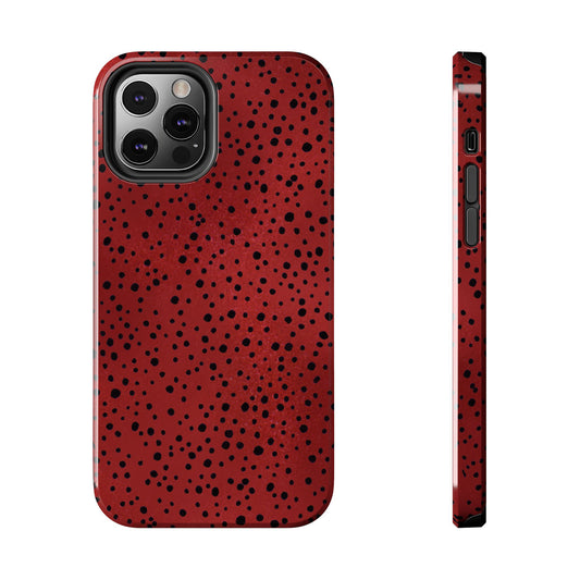 Red phone case with black speckles, triple camera cutout, side view shows volume buttons.