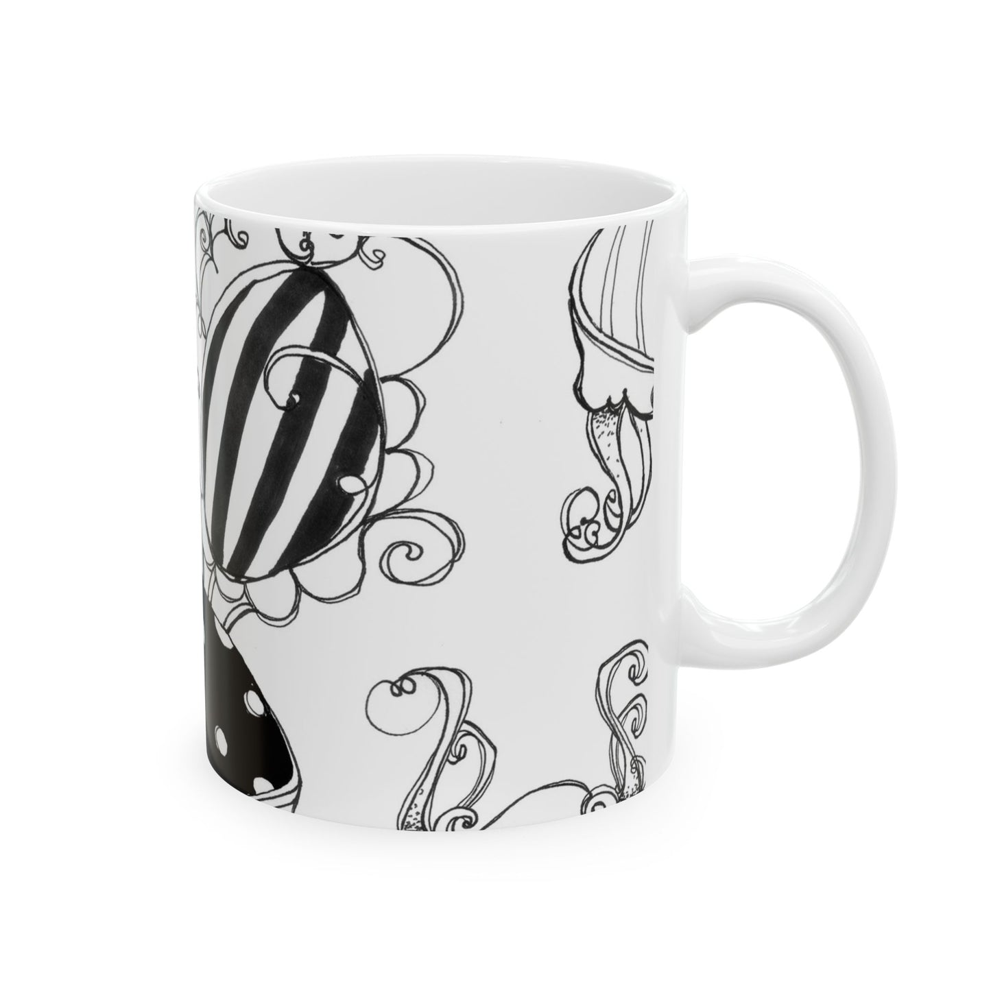 White mug with black floral and abstract swirl designs featuring bold stripes and curves.