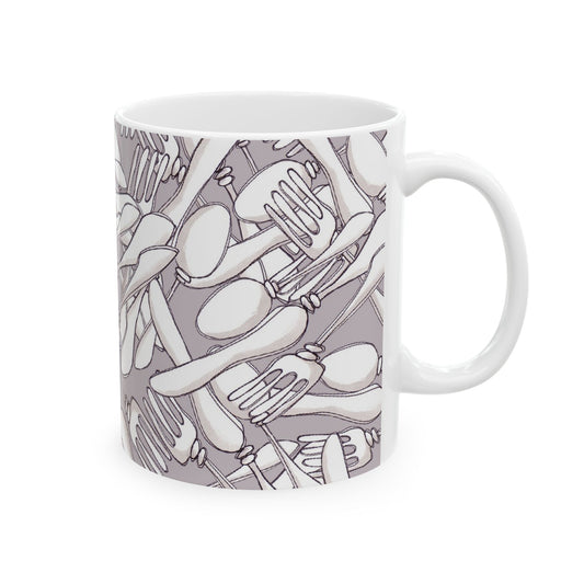 White mug with a gray pattern of overlapping forks, spoons, and knives.