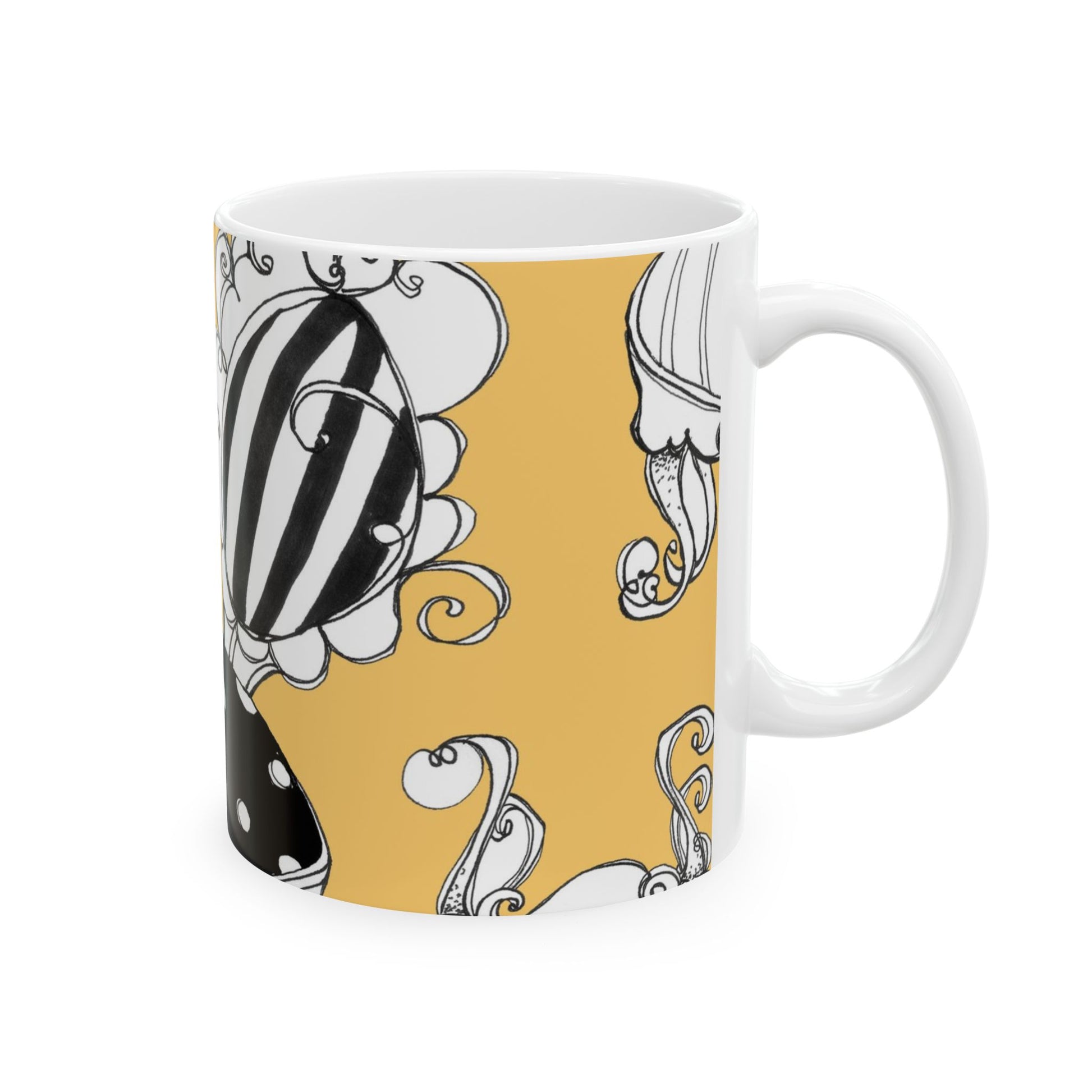 White mug with a yellow background, featuring black and white abstract floral designs.