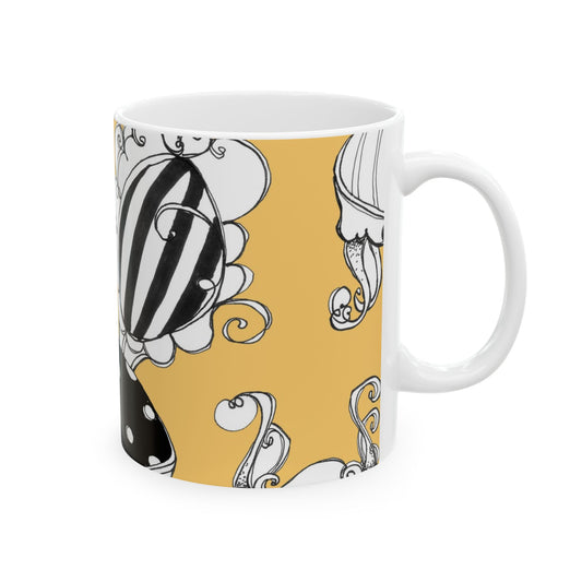 White mug with a yellow background, featuring black and white abstract floral designs.