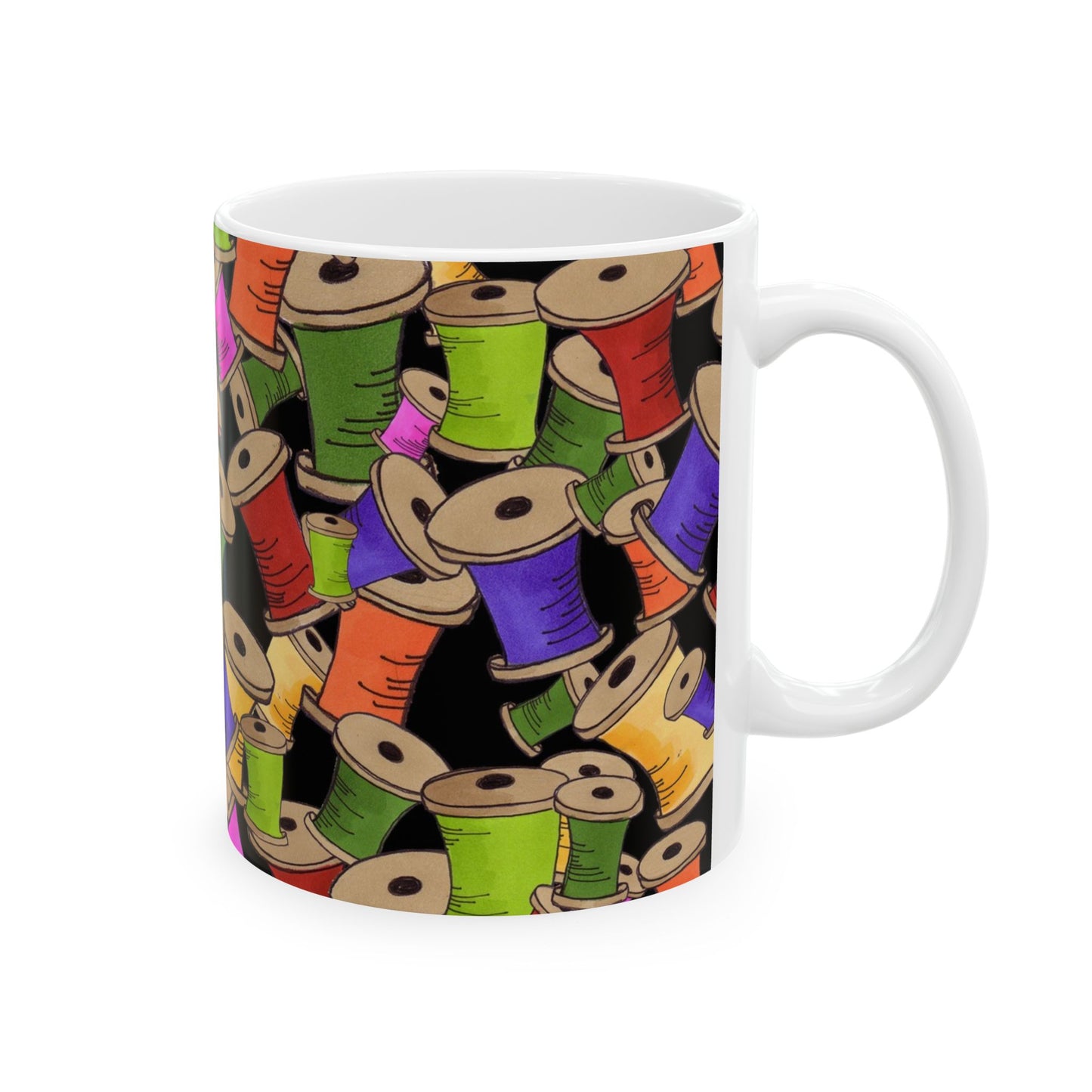 White mug with colorful thread spools in green, purple, orange, and pink on a black background.