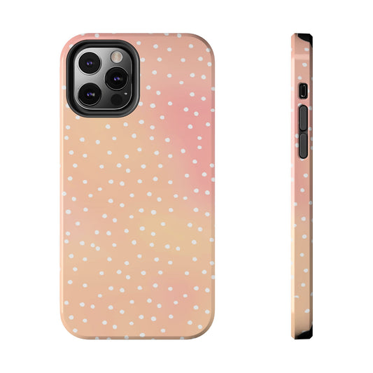 Peach and pink phone case with white polka dots, showcasing camera cutout and side buttons.