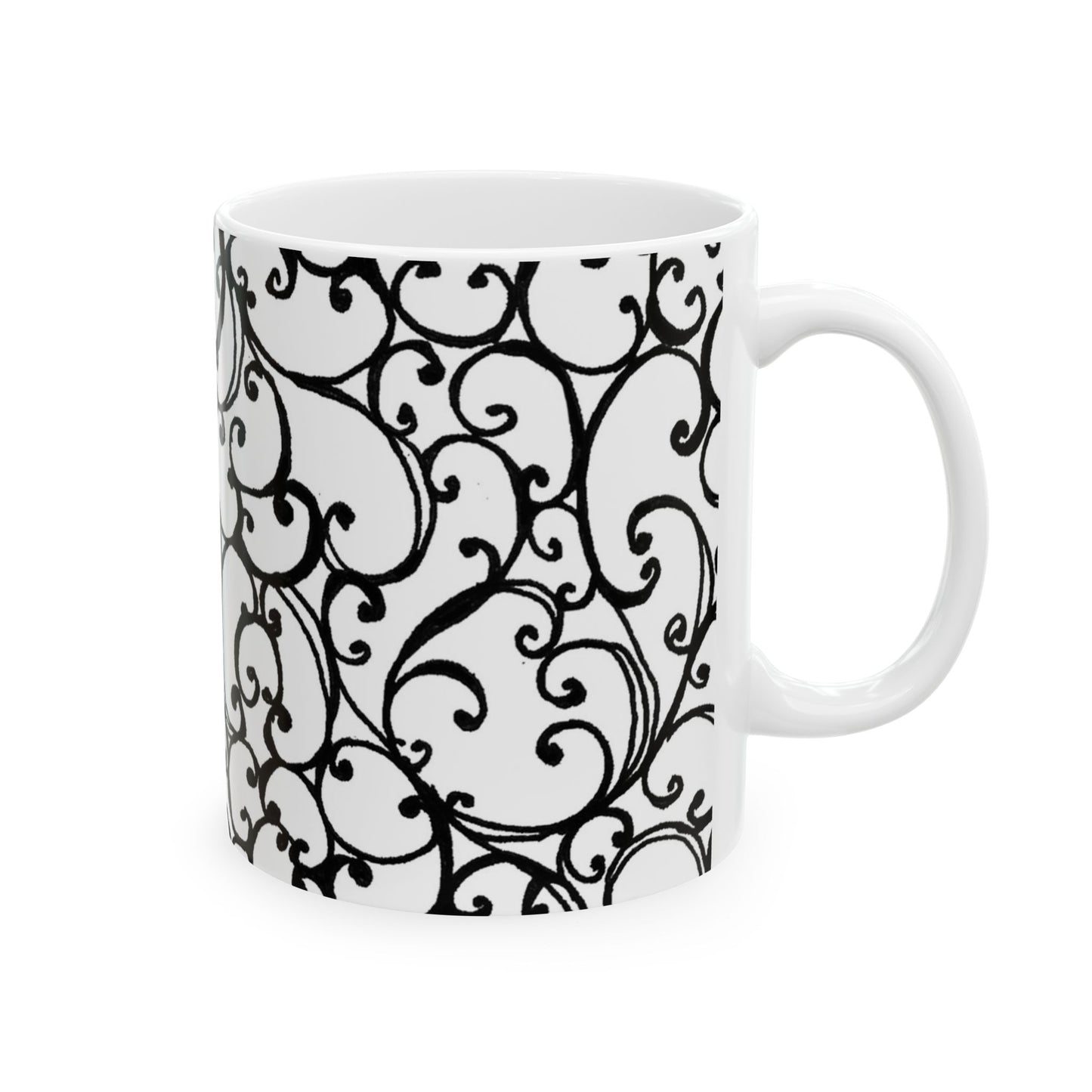 White mug with intricate black swirl patterns covering the surface.