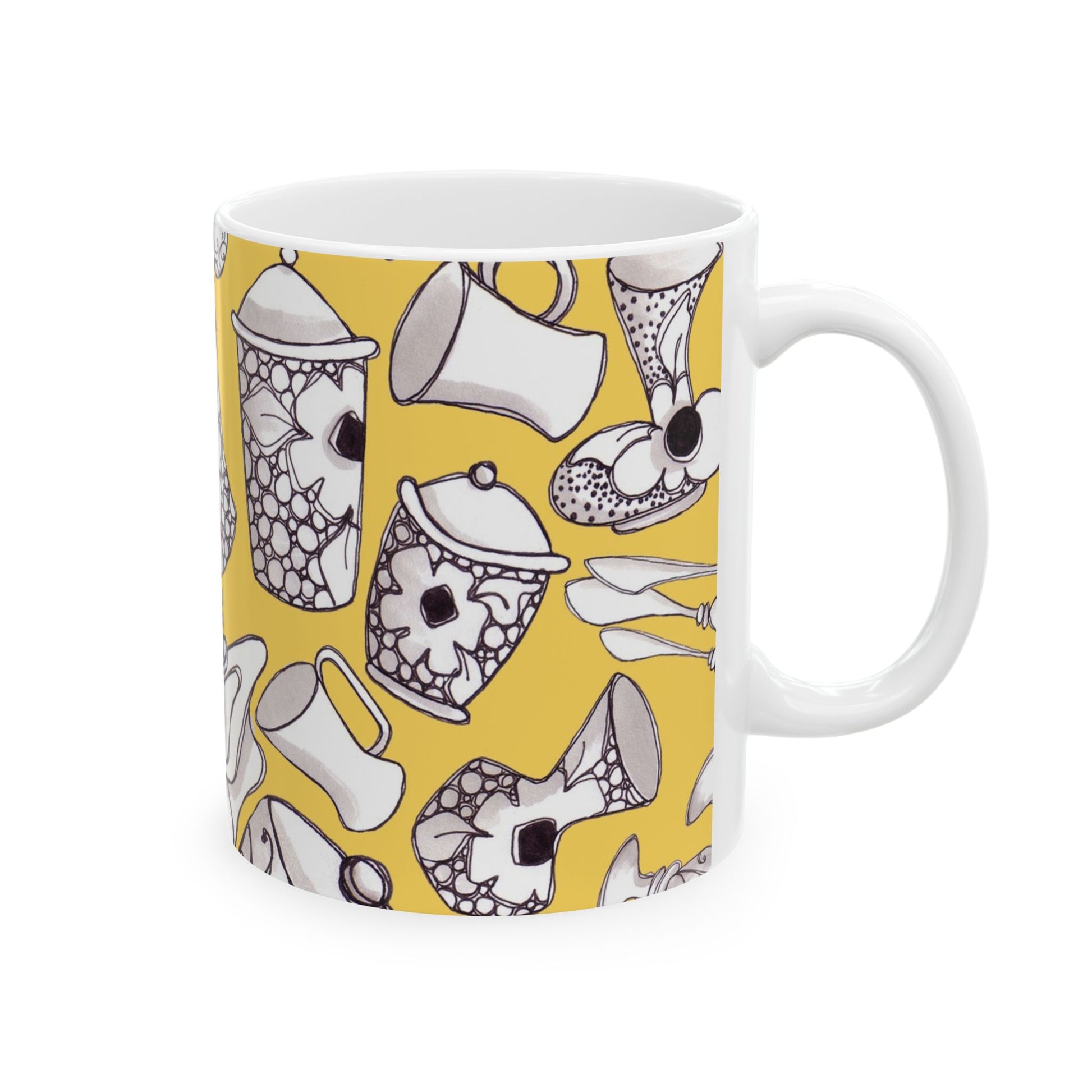 White mug with black floral and kitchenware patterns on a yellow background.
