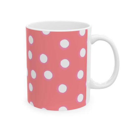 White mug with a pink background and white polka dots.